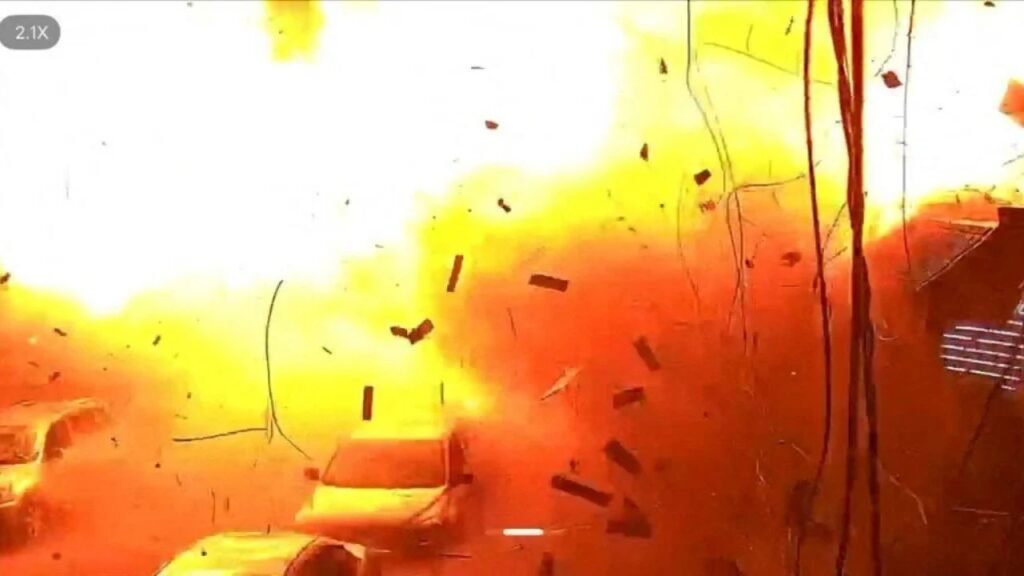 Surveillance footage shows vehicles parked on a street as debris falls during an explosion from a Russian strike, amid Russia's attack on Ukraine, in Kharkiv, Ukraine, October 11, 2026, in this frame from a handout video. Kharkiv Prosecutor's Office/via REUTERS