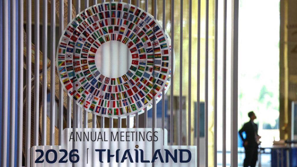 A person stands next to the logo of the 2026 IMF-World Bank Annual Meetings, ahead of the meeting at Queen Sirikit National Convention Center (QSNCC), in Bangkok, Thailand, October 9, 2026. Reuters/Athit Perawongmetha