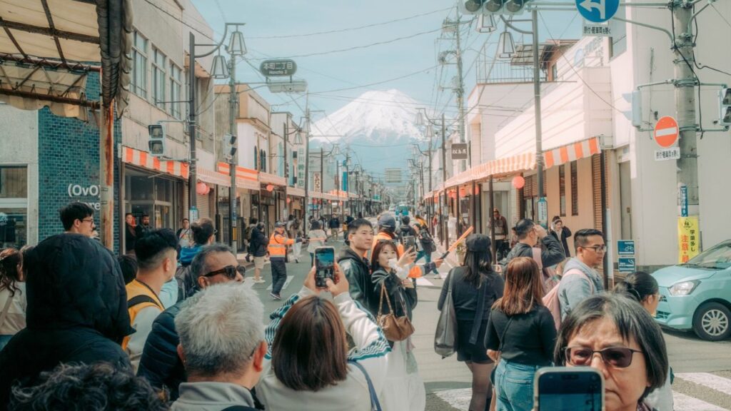 Tourists crowd a street in Fujiyoshida, Japan, April 9, 2026. Prime Minister Sanae Takaichi’s government has recently raised the price of some tourist visas by more than 400 percent. (Kentaro Takahashi/The New York Times)