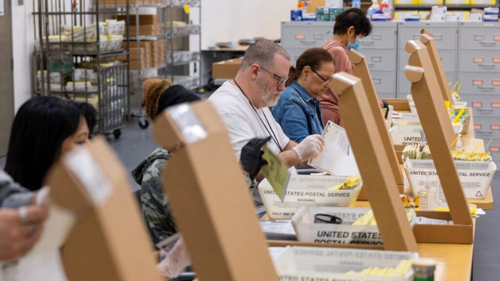 Election workers extract ballots as they help process mail-in ballots at the Registrar of Voters facility in San Diego, California, US, October 23, 2026. Reuters/Mike Blake/File Photo