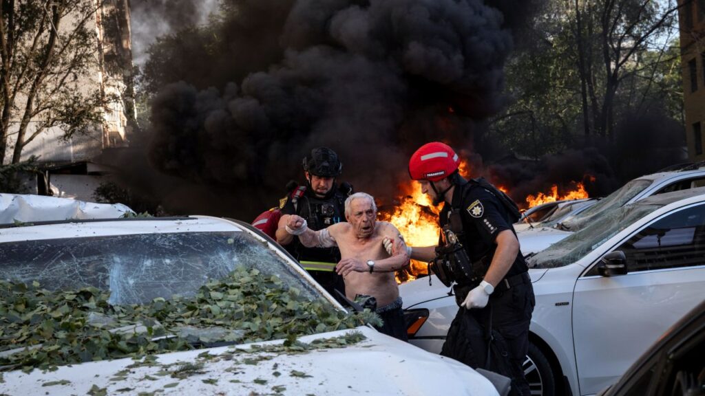 Image of rescue workers assisting an injured man after a Russian aerial strike in Ukraine