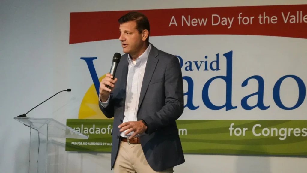 Image of Rep. David Valadao talking on stage. He's in a sport jacket, open-collar shirt and khaki pants