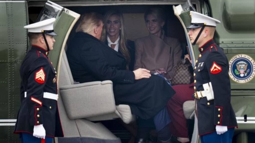 White House Press Secretary Katie Zacharia and Special Assistant Natalie Harp join President Donald Trump in Marine One as he arrives in Wasilla, Alaska, for a campaign rally, Tuesday, Oct. 13, 2026. The president has stepped up his offers of financial rewards to voters with just weeks until the midterms and in Alaska, announced pardons. (Doug Mills/The New York Times)