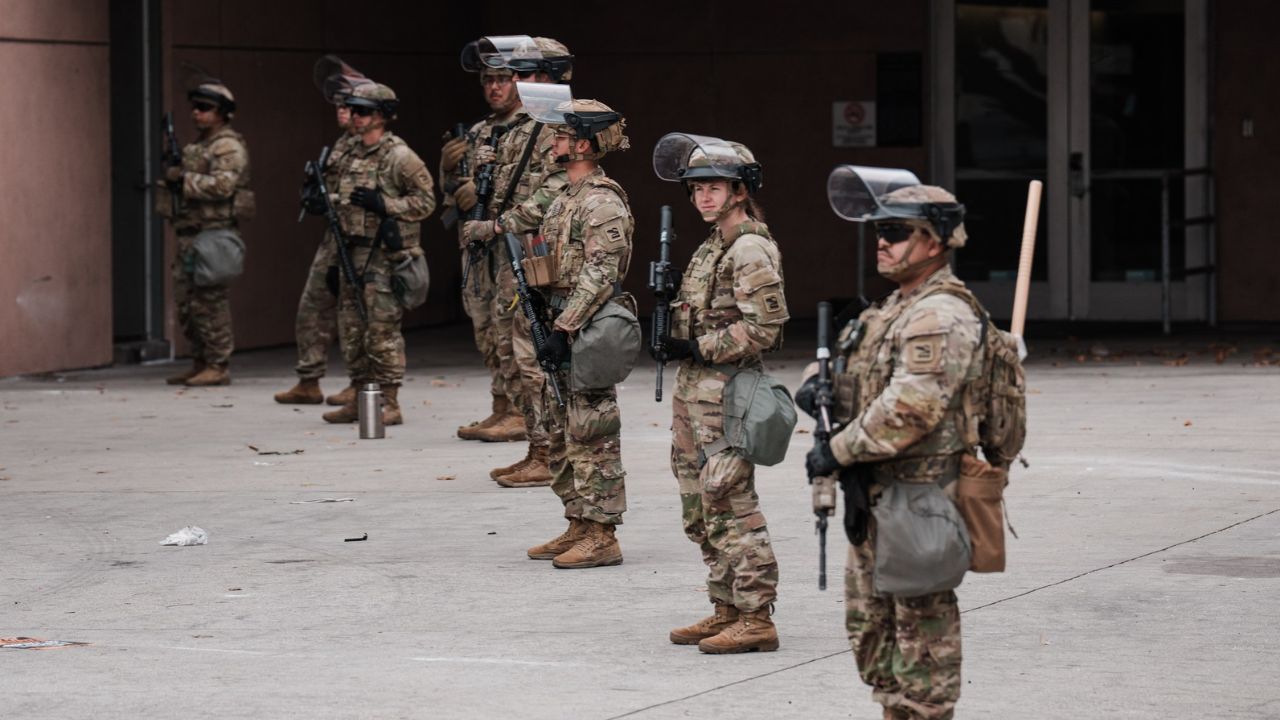 A small group of protesters are watched outside the Metropolitan Detention Center after President Donald Trump deployed the California National Guard, in Los Angeles, June 8, 2025. President Trump violated federal law by seizing control of the California National Guard last year and deploying troops to the streets of Los Angeles during immigration protests, a federal appeals court ruled on Friday, Oct. 24, 2026. (Gabriela Bhaskar/ The New York Times)